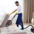 young-man-cleaning-sofa-with-vacuum-cleaner-leaving-room-home_130111-3594